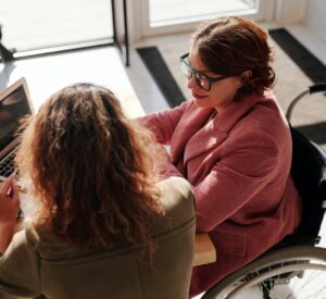 Two people working together at a laptop
